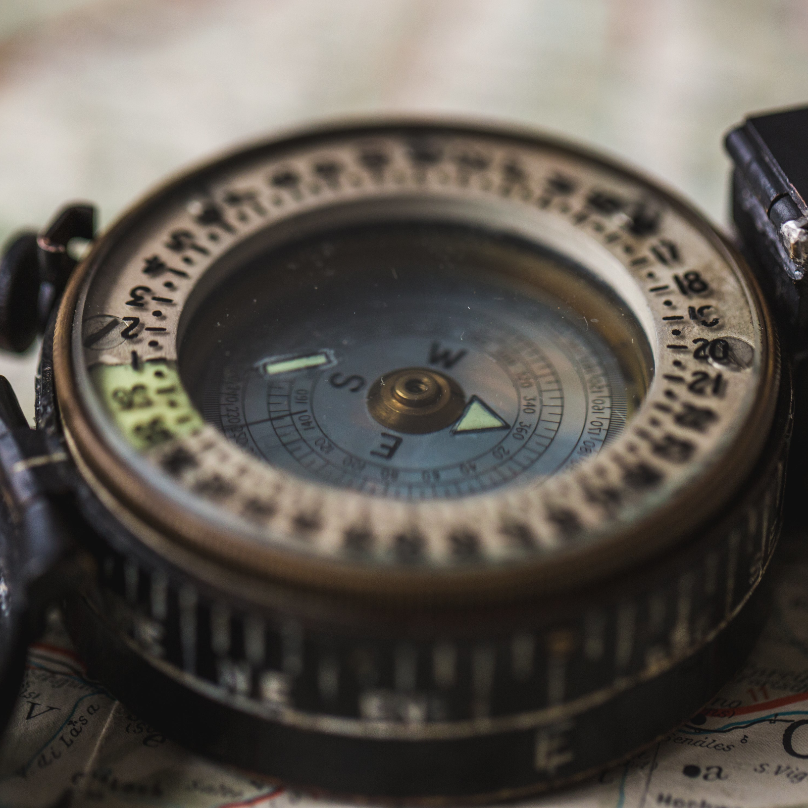 Close-up of a compass on an old map